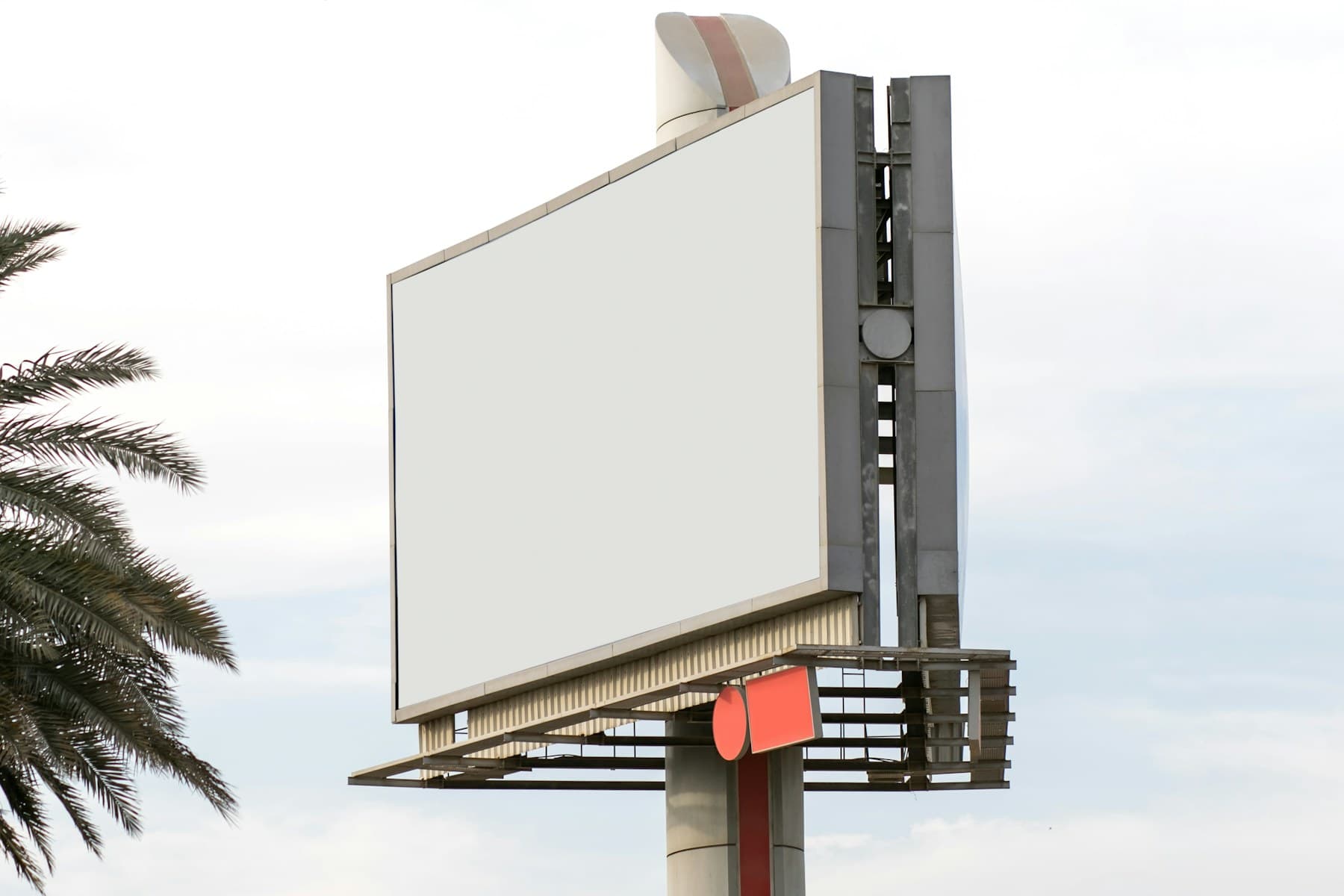 A blank billboard against a bright blue sky