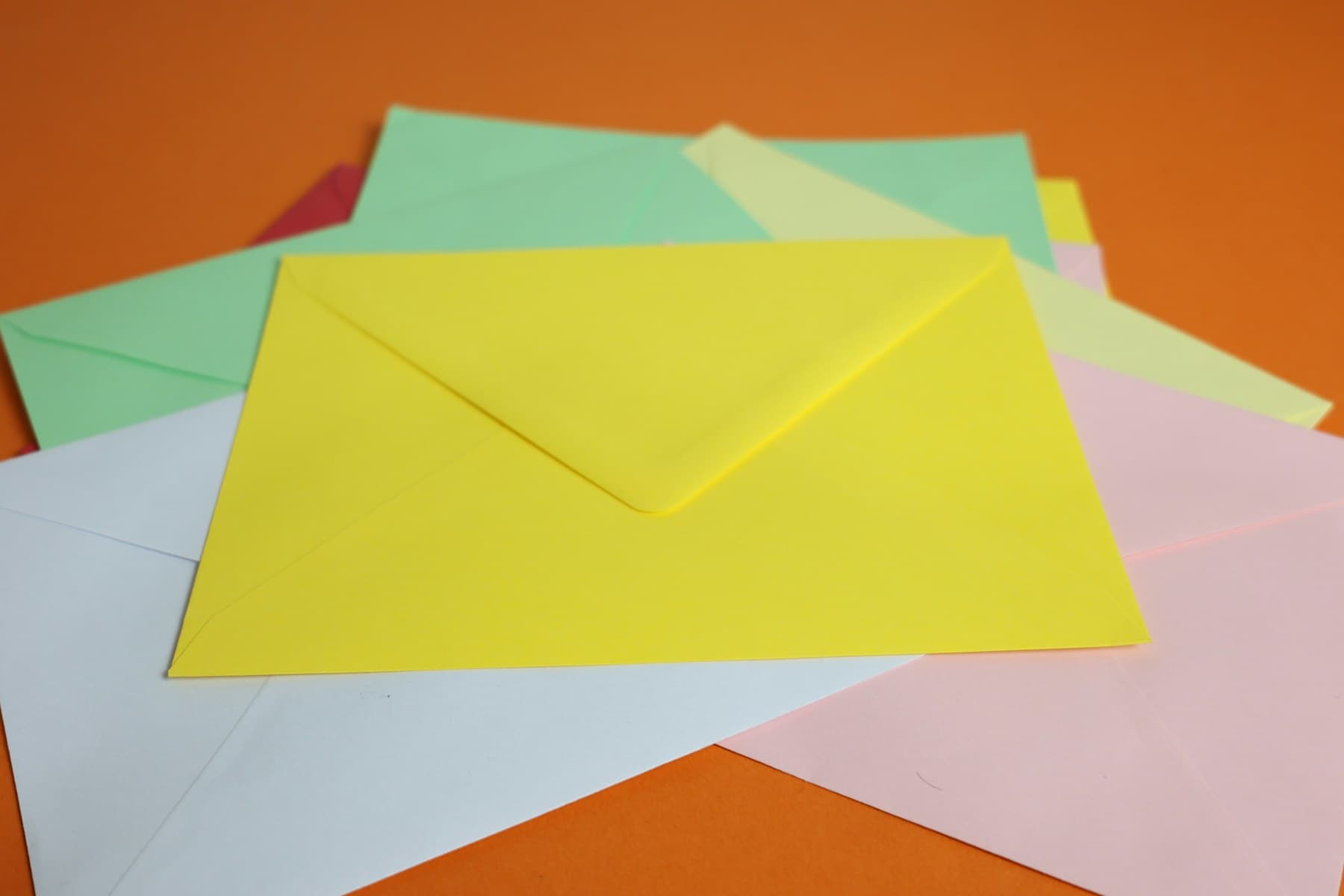 A bright stack of colorful envelopes